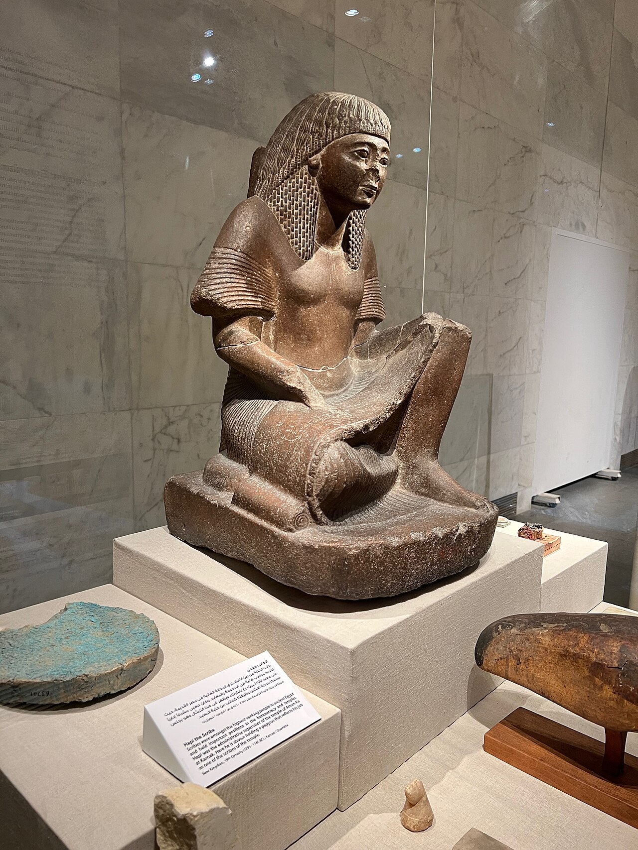 Statue of Hapi the Scribe with visible carved and painted surfaces